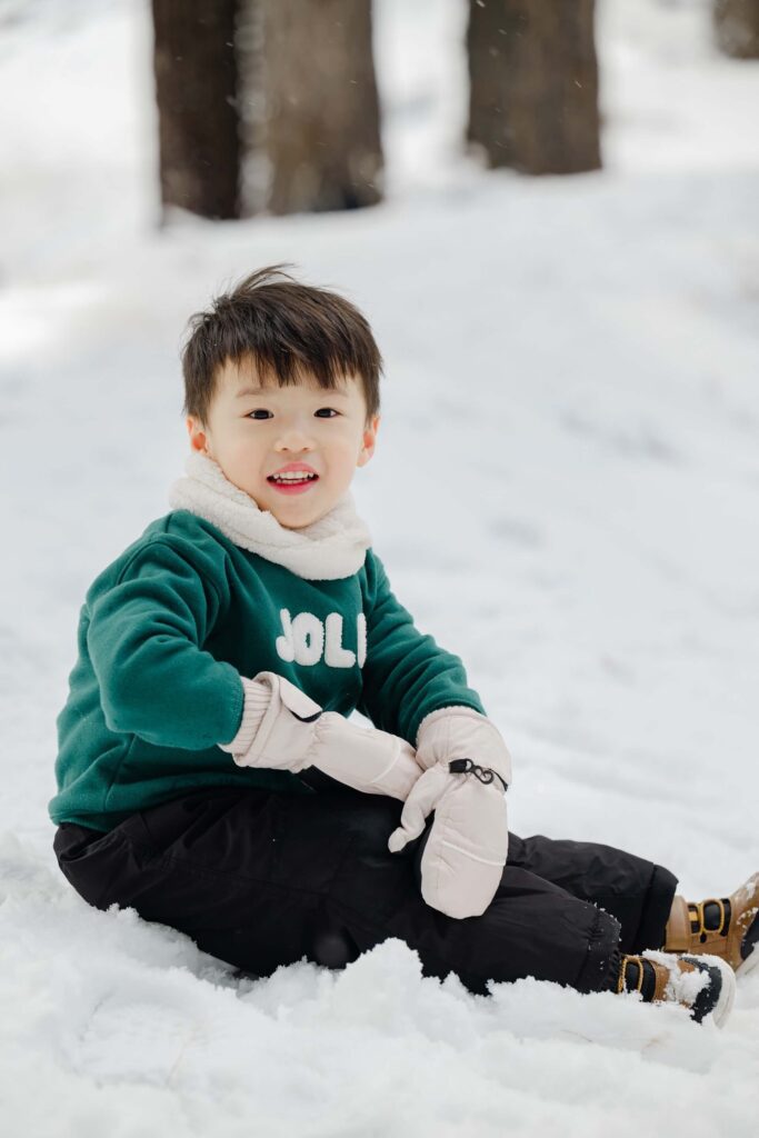 toddler smiling sitting during winter portrait session