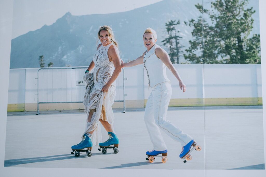 Spread page of wedding album of two brides rollerskating during High Camp Palisades Tahoe cocktail hour