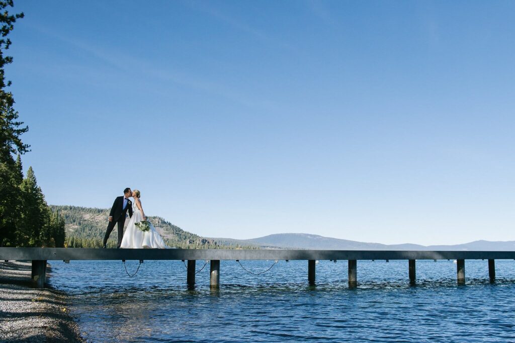 Bride and Groom kissing on a pier in Lake Tahoe