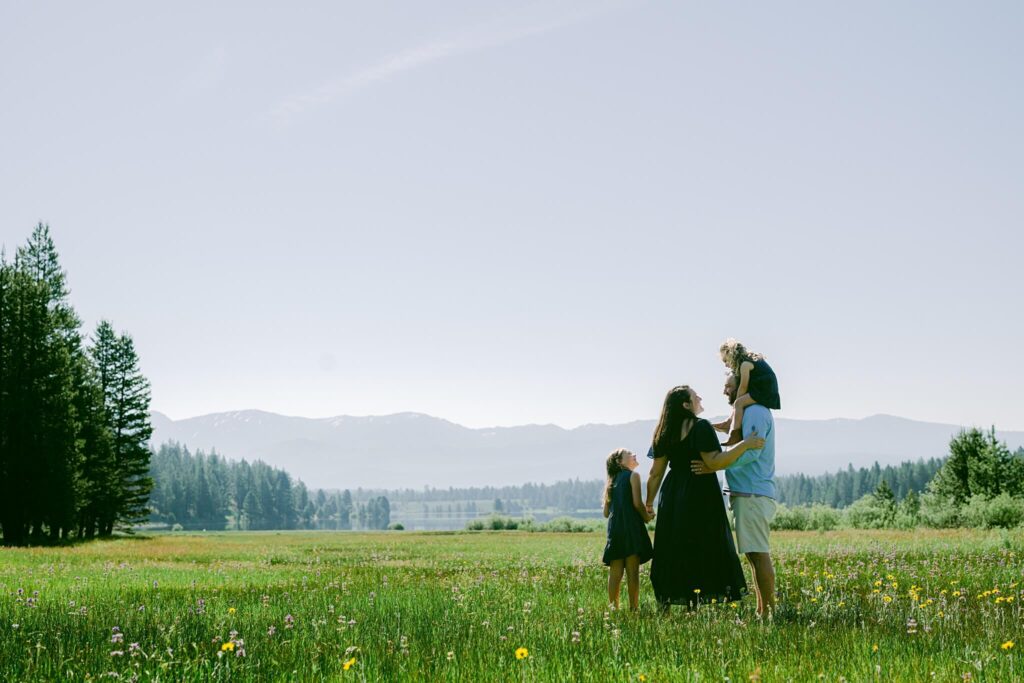 North lake Tahoe family photographer captures a family standing in a field of flowers in Truckee