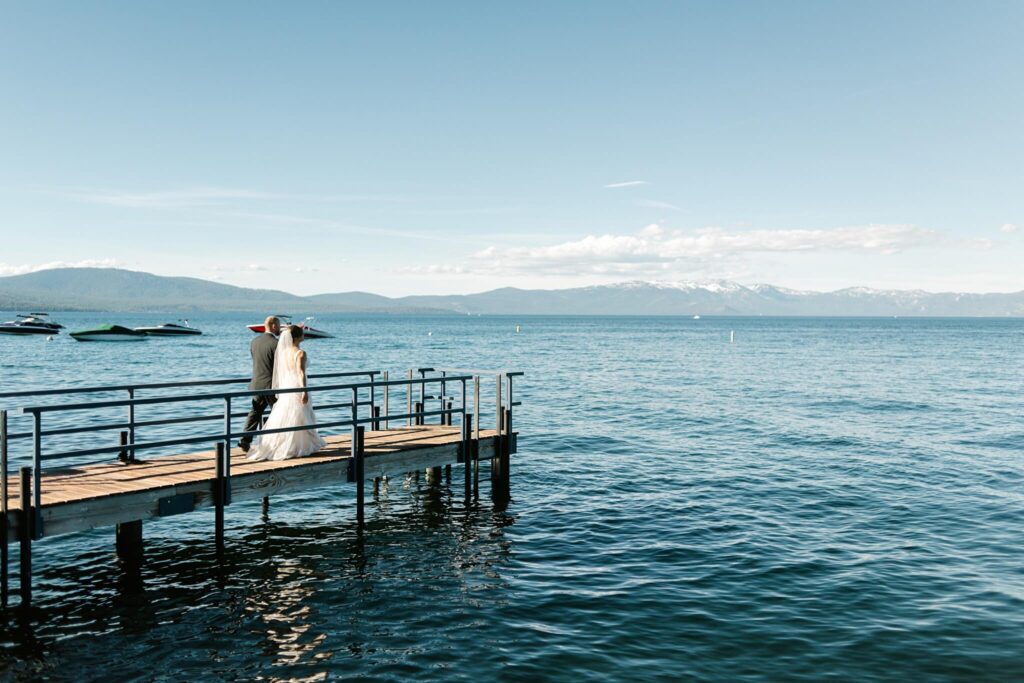 Bride and Groom at end of pier at Chambers Landing on a sunny day captured by Annie X