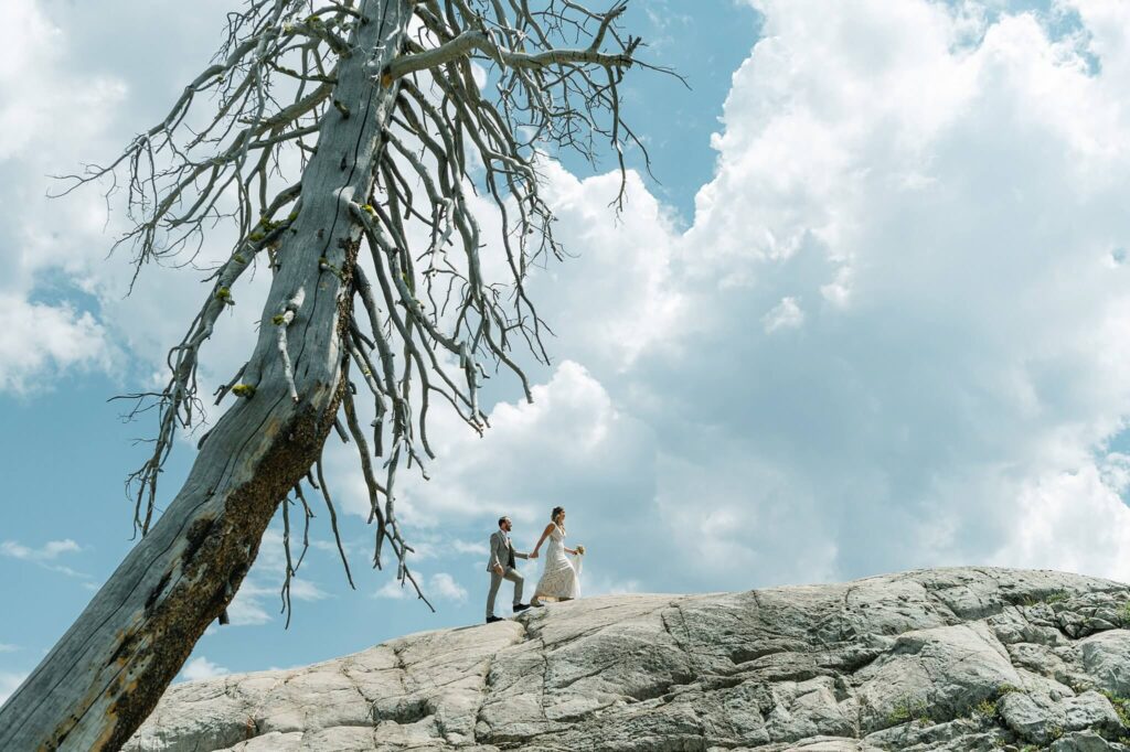 White Wolf Tahoe bride and groom on the rocks and huge white puffy cloud