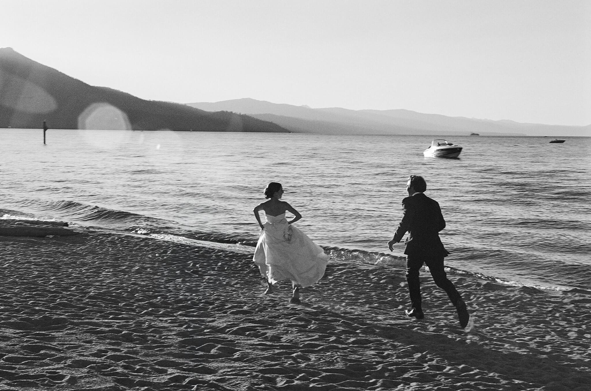 Tahoe Keys bride and groom running on beach photographed by Annie X Photographie