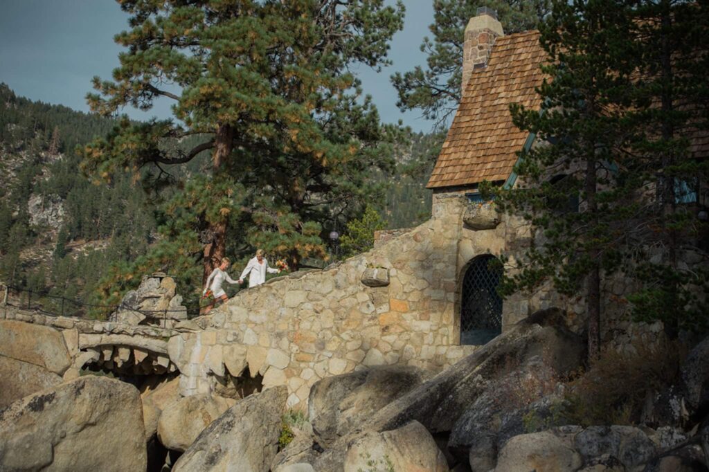 Two brides Just married walking up walkway at Thunderbird Lodge in Lake Tahoe photographed by Annie X Photographie