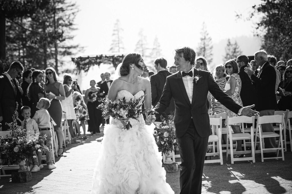 Bride and groom just married walking down the aisle looking at each other at Everline resort