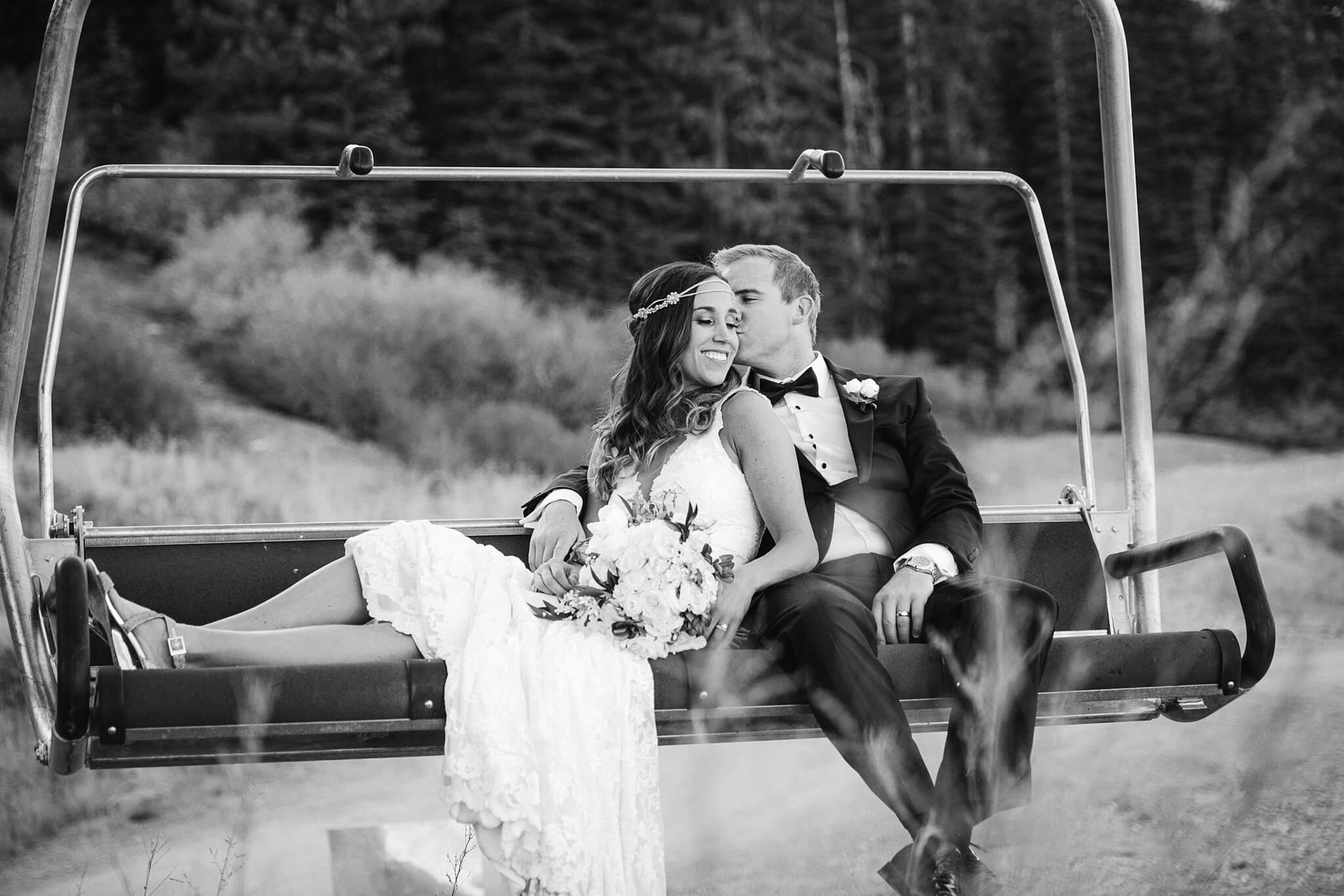 Lake Tahoe Mountain Wedding Venues vibe with Bride and Groom taking a moment on a chairlift at The Ritz Tahoe on Northstar Tahoe captured by Truckee wedding editorial photographer Annie X Photographie