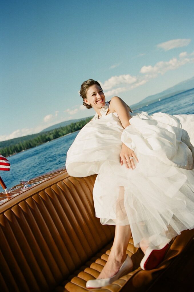 Film image of bride on a vintage boat just married on Lake Tahoe private lakeside estate