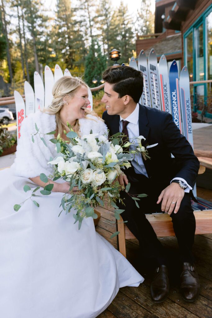 Just married bride and groom on deck of Sunnyside Lake Tahoe in a late fall wedding photographed by Annie X