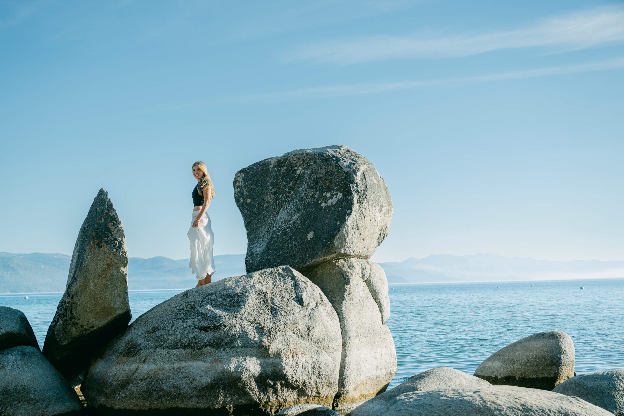 Senior sessions Tahoe with a Truckee High senior on top of boulders in Lake Tahoe photographed naturally by your Tahoe Senior photographer Annie X Photographie