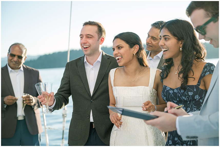Newlyweds signing their marriage license on the Tahoe boat wedding at sunset
