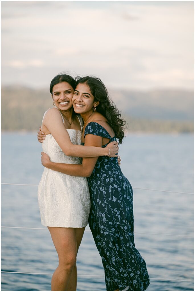 Bride and her sister on Cloud Sierra catamaran after their Tahoe boat wedding
