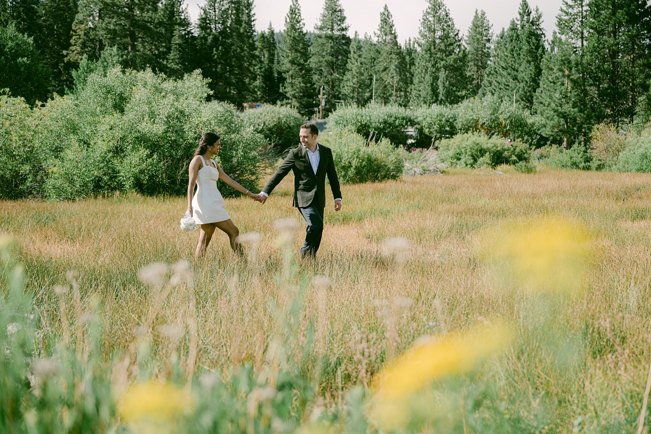 Bride and Groom walking in Lake Tahoe meadow looking at each other