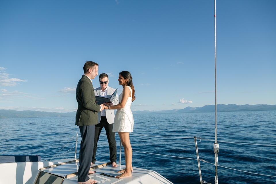Bride and groom during Lake Tahoe boat wedding with mountain backdrop