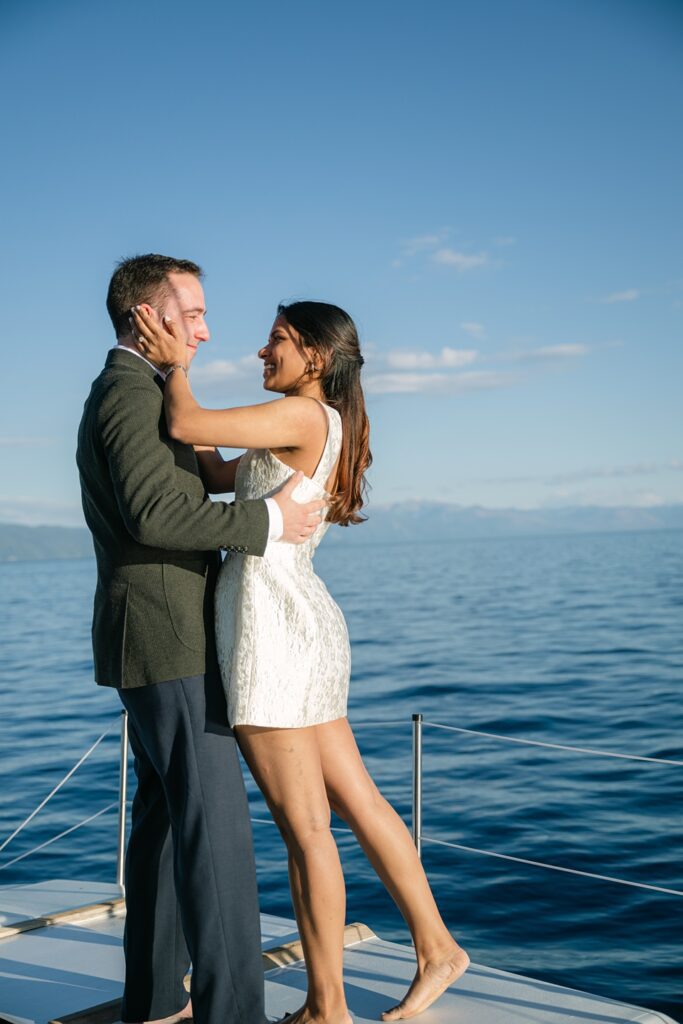  Lake Tahoe boat wedding ceremony on the Sierra Cloud catamaran just married kiss after ceremony at golden hour