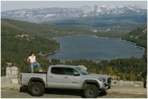 Truckee senior photographer capturing this senior girl's Tacoma up on Donner Summit with Donner Lake in teh backdrop