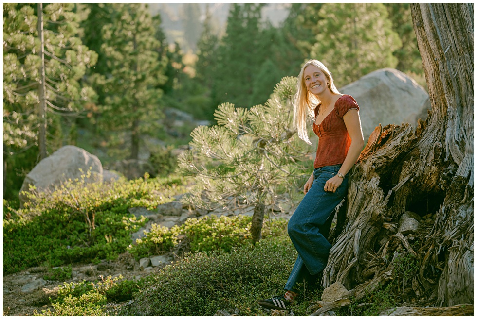 Palisades Tahoe senior photos leaning on wood stump with North Lake Tahoe senior photographer Annie X Photographie