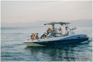 lake Tahoe family photographer captures Boat ride during golden hour with candid smiles and laughter
