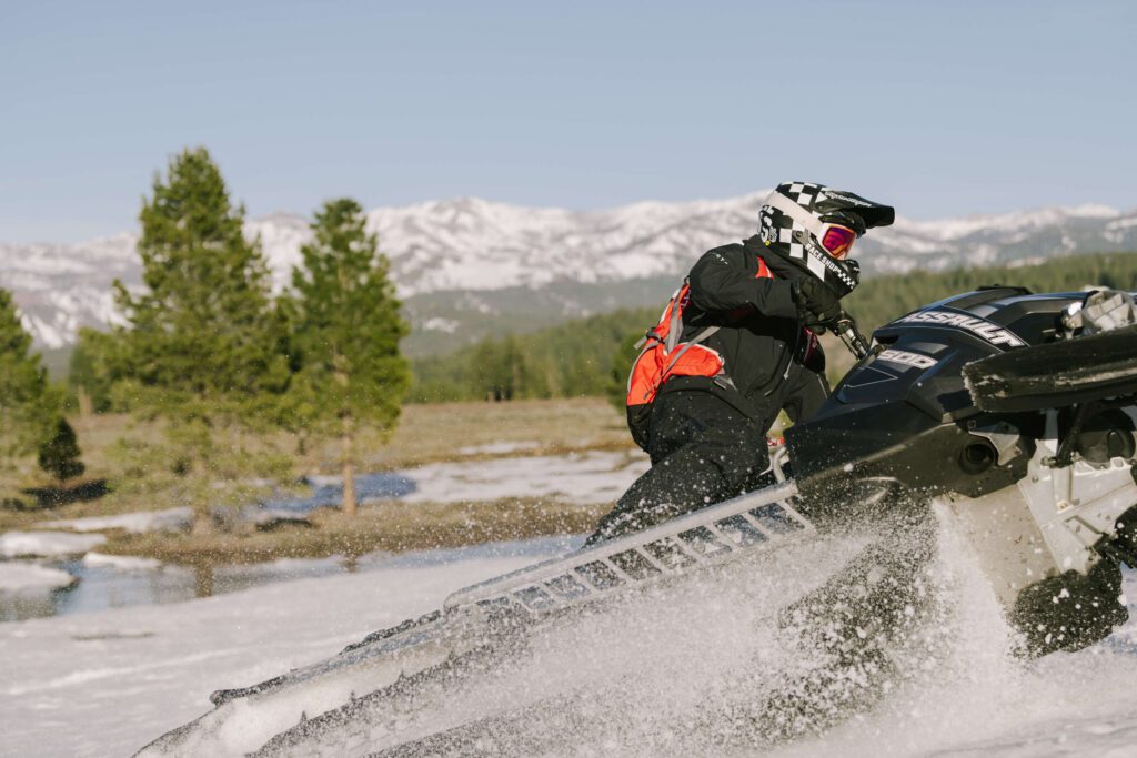 Truckee senior photos with a snowmobile photographed by truckee senior photographer