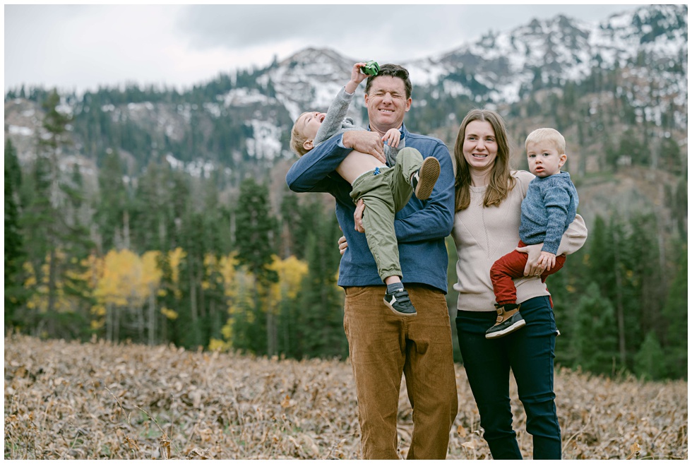 Tahoe family session fun in the mountains with two toddlers. One of them not cooperating snowy mountain in backdrop