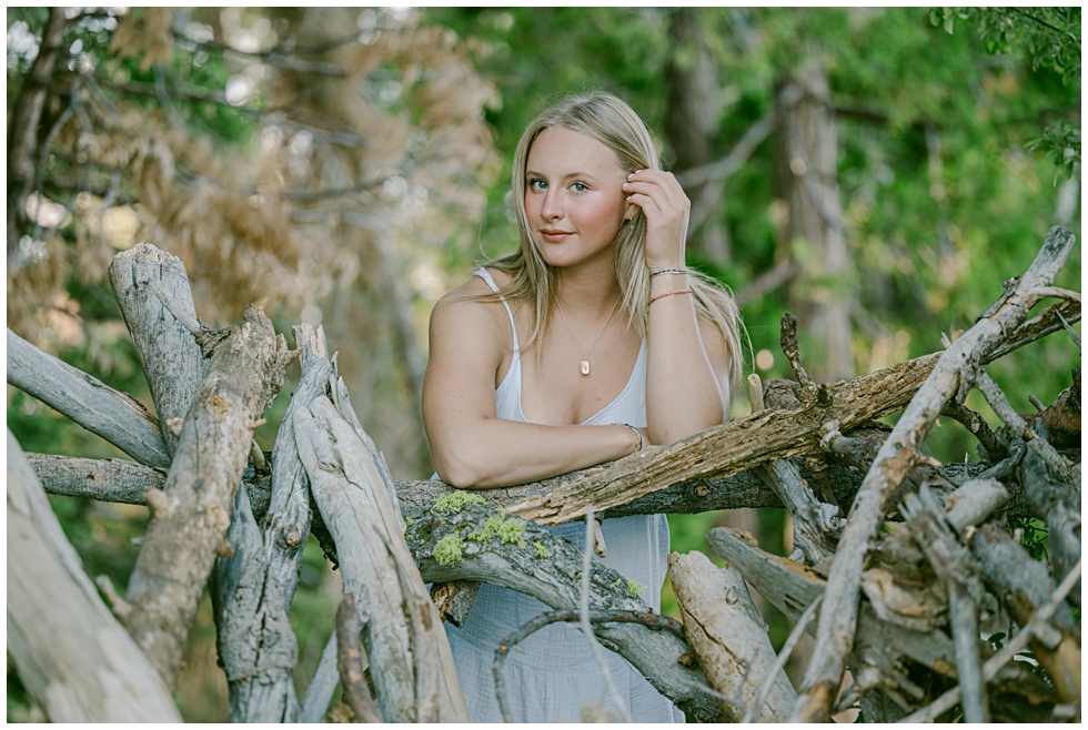 Editorial senior portrait at Sugar Pine Point amongst trees with soft light