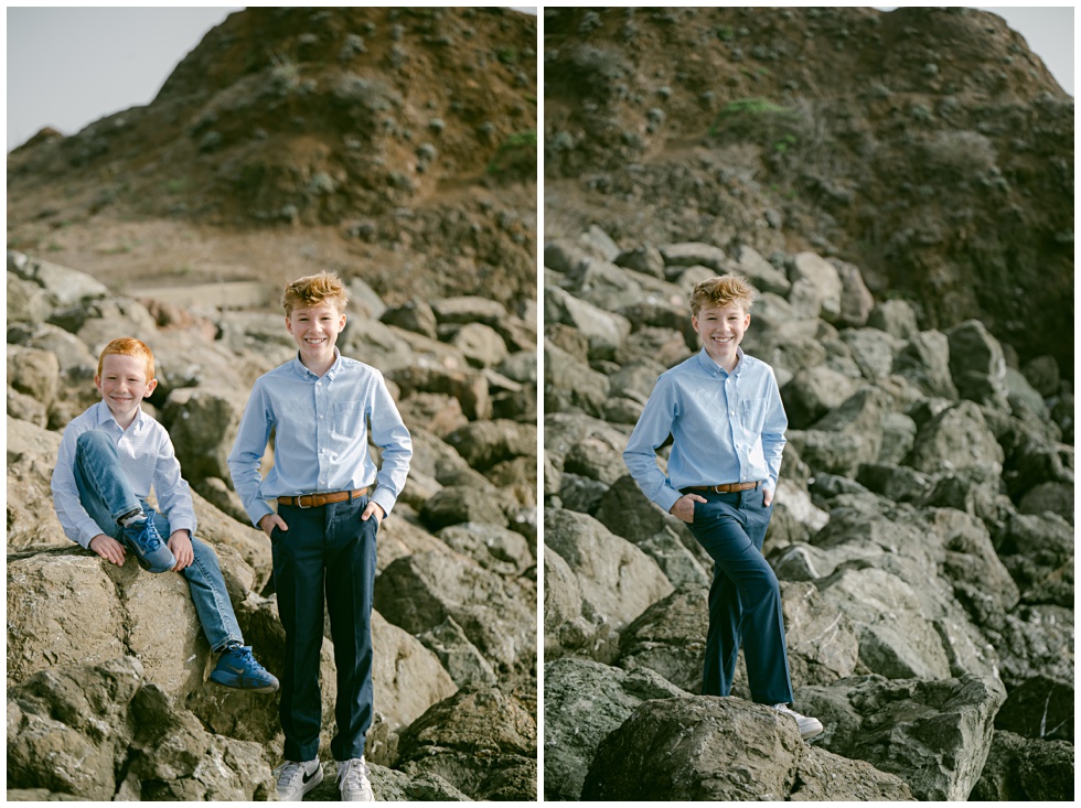 Family standing on rocky shoreline during Point Cavallo photo session