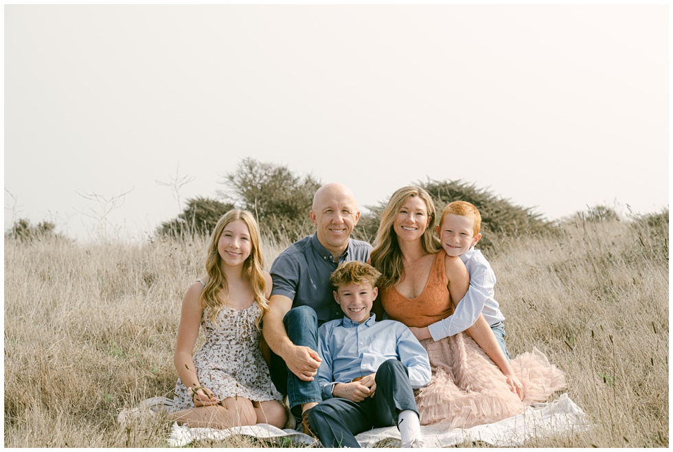 Bay Area family photographer Annie X capturing natural family portraits sitting in tall golden grass
