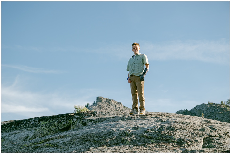 Boy standing tall on Donenr Summit photographed by Tahoe family photographer Annie X Phtoographie