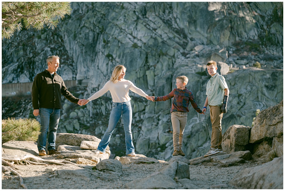 Truckee family photos of family holding hands golden light hitting Donner Summit granite