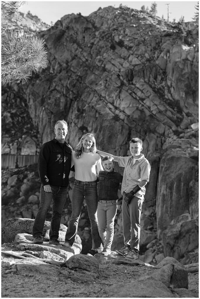 Black and white portrait of Tahoe family photo session parents and their two boys with granite walls behind them 