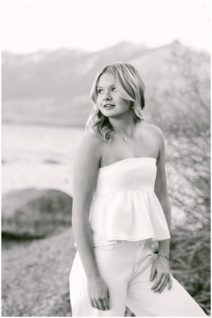 Truckee senior photographer black and white editorial portrait of Class of 2026 senior in white strapless top with Sierra Nevada mountain and Lake Tahoe backdrop Sugar Pine Point West Shore