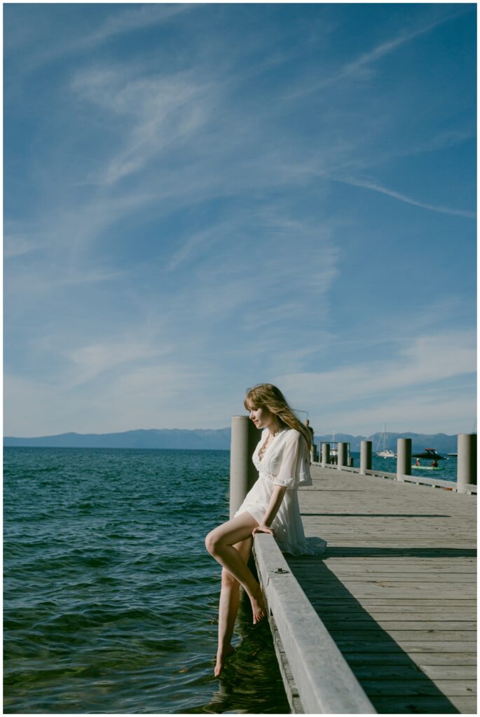 Senior sitting on the pier railing above Lake Tahoe at Valhalla