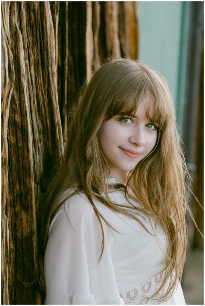 Close up senior portrait against weathered wood at Valhalla, South Lake Tahoe