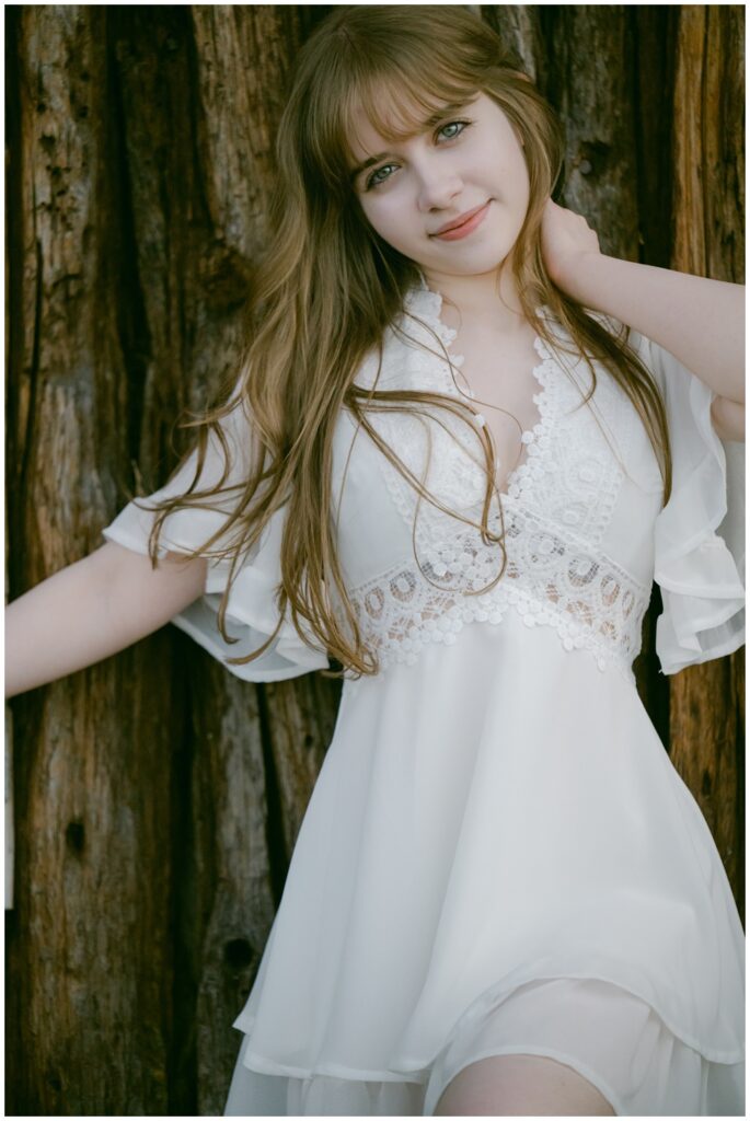 Senior portrait in a white lace dress near the Valhalla boathouse, South Lake Tahoe