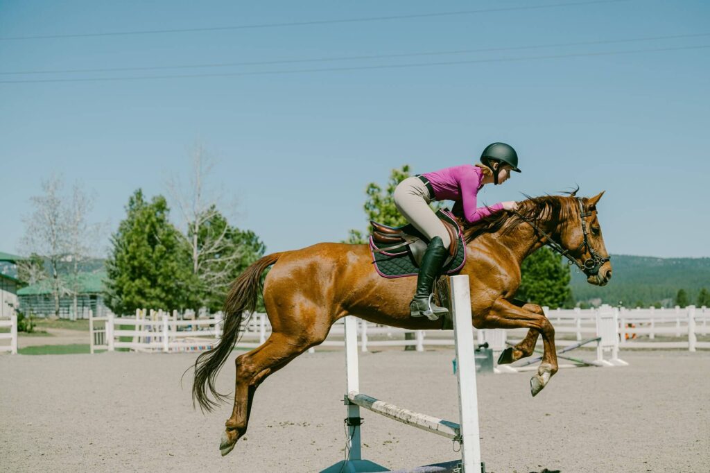 senior gilr session while horse jumping practice
