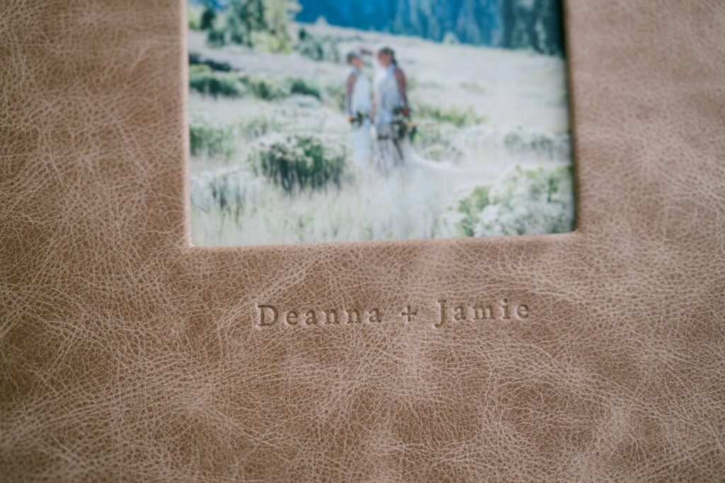 Heirloom wedding album showing embossed clear names under cover opening